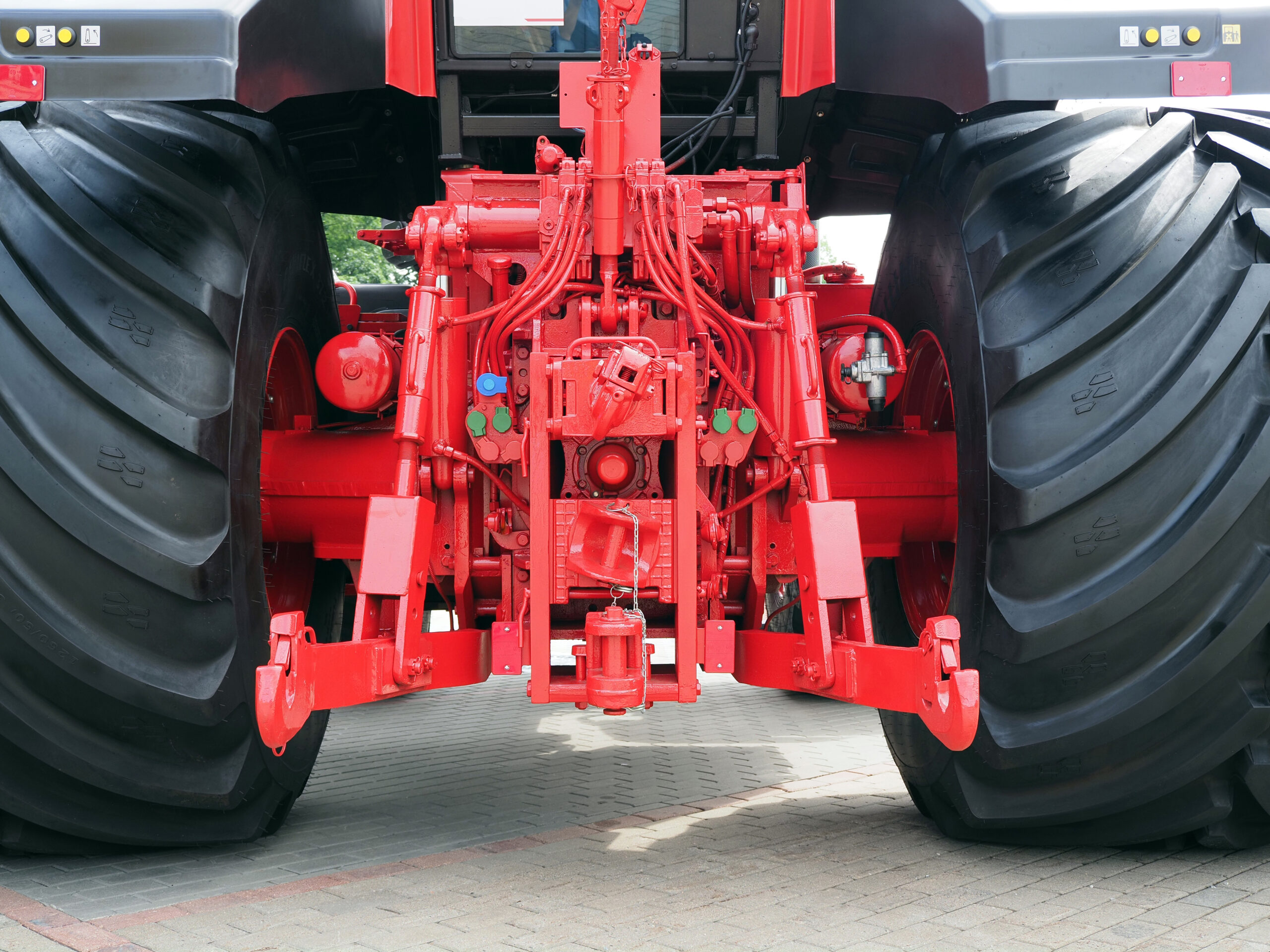 close-up of a red hydraulic system and hitch on a tractor
