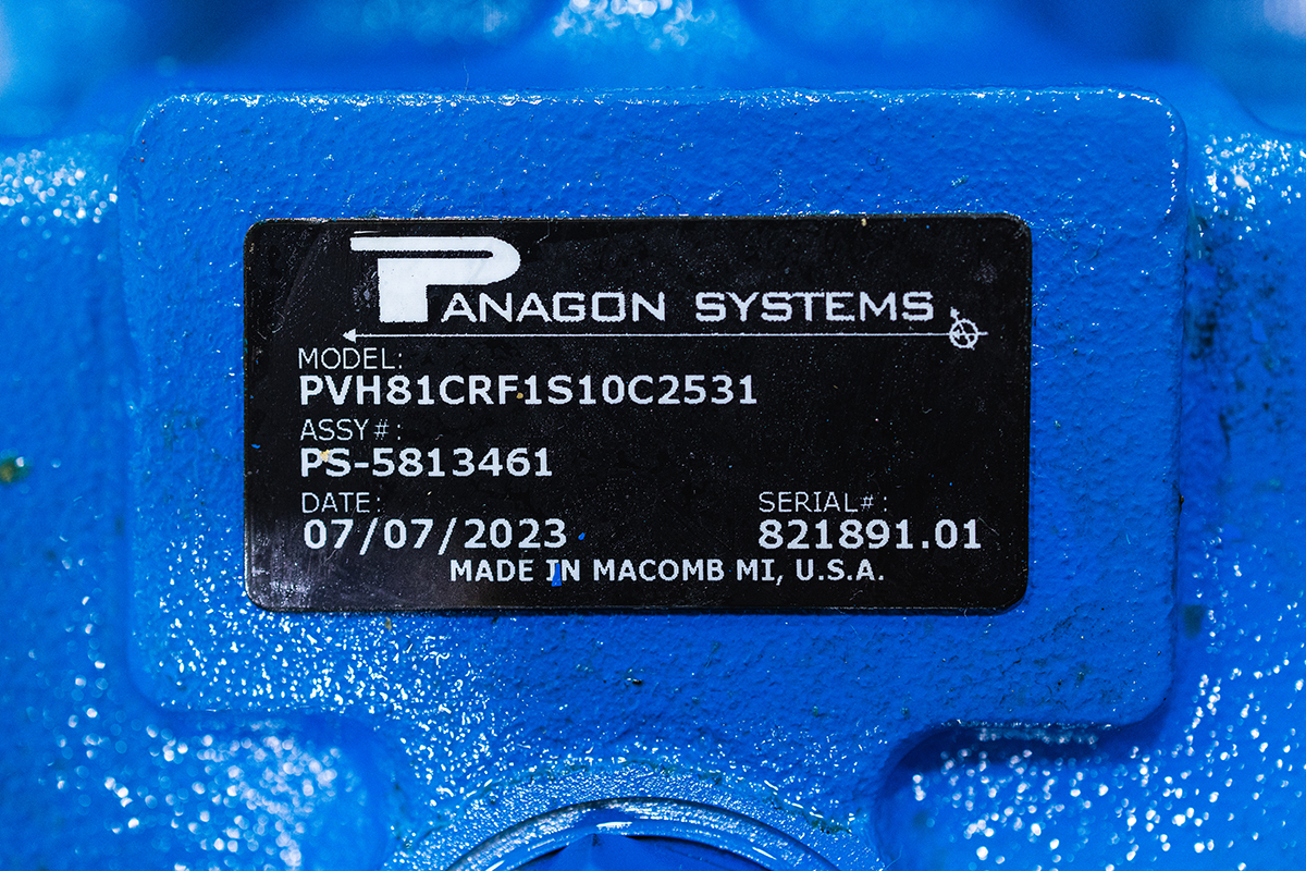A close-up of a Panagon Systems tag/label featuring the model number, assembly number, date of manufacture, and serial number