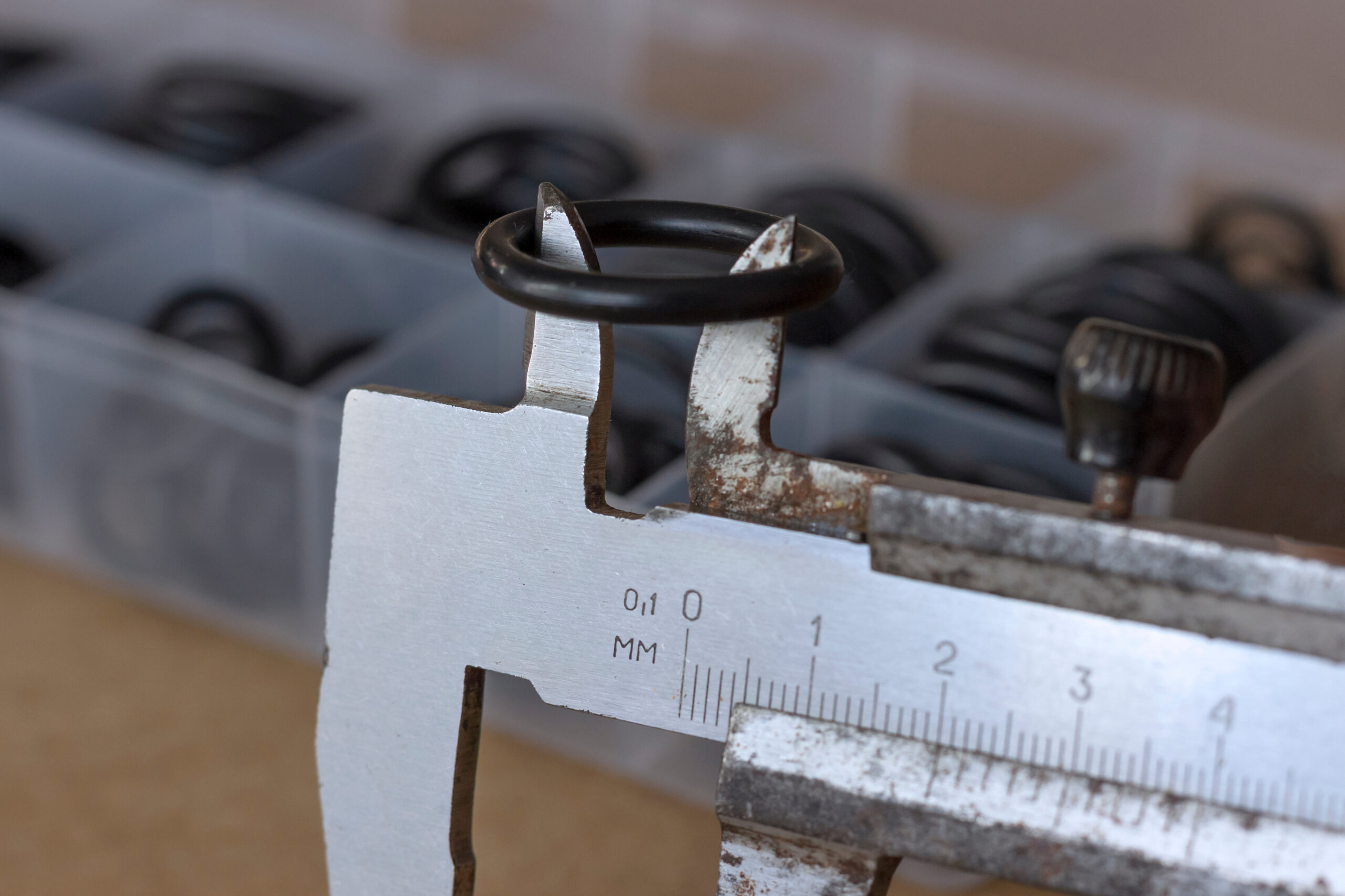 An O-ring is placed on calipers to measure the inside diameter